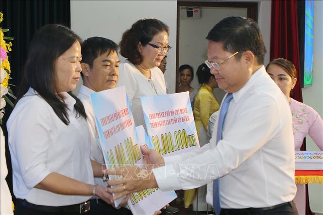 Giám đốc Sở Lao động, Thương binh và Xã hội Thành phố Hồ Chí Minh Lê Văn Thinh tặng quà cho đại diện người cao tuổi có hoàn cảnh khó khăn ở các quận huyện và thành phố Thủ Đức tại buổi lễ. Ảnh: Thanh Vũ-TTXVN
