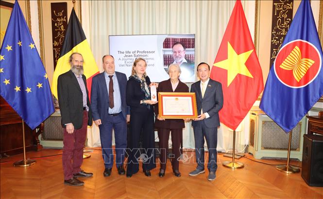 Vietnamese Ambassador to Belgium Nguyen Van Thao hands over the order to the late professor's relatives. VNA Photo.: Hương Giang
