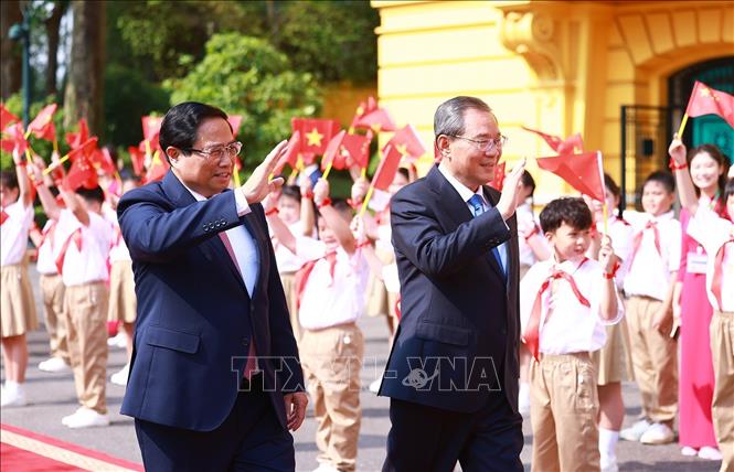 Thủ tướng Phạm Minh Chính và Thủ tướng Trung Quốc Lý Cường với thiếu nhi Thủ đô. Ảnh: Dương Giang – TTXVN
