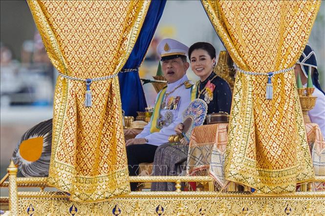 Đương kim Quốc vương Thái Lan Maha Vajiralongkorn (Vua Rama X) và Hoàng hậu Suthida ngồi trên thuyền rước hoàng gia. Ảnh: Đỗ Sinh – P/v TTXVN tại Thái Lan
