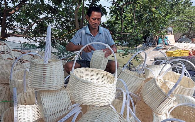 Gia đình anh Nguyễn Văn Đức ở thôn Thượng, xã Phú Túc sản xuất giỏ đựng hàng cung cấp cho thị trường. Ảnh: Trần Việt - TTXVN