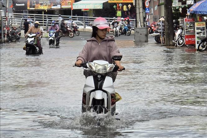 Triều cường dâng gây ảnh hưởng đến việc lưu thông, đi lại của người dân trên địa bàn thành phố Cà Mau (Cà Mau). Ảnh: Kim Há - TTXVN