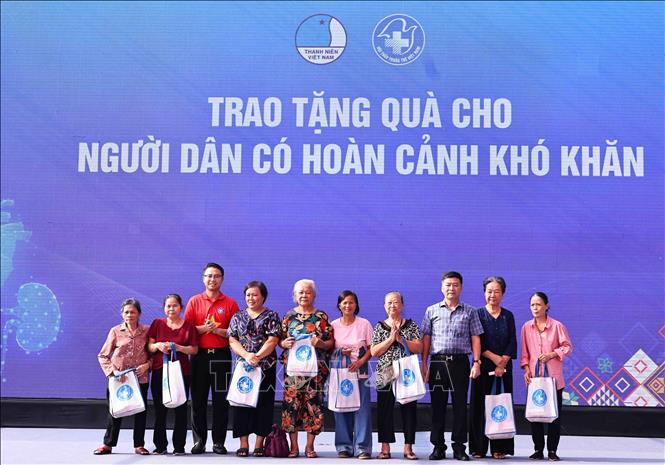 Ban tổ chức trao quà cho các gia đình chính sách, có hoàn cảnh khó khăn trên địa bàn quận Tây Hồ. Ảnh: Minh Đức – TTXVN