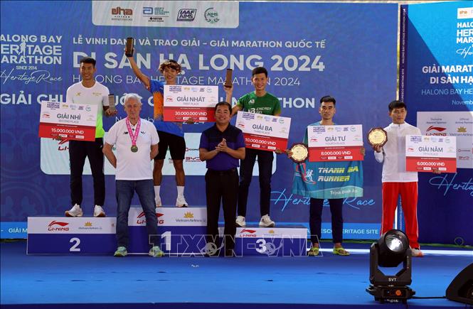 Ban Tổ chức trao giải cho các vận động viên đạt thành tích ở cự ly 42km. Ảnh: Đức Hiếu - TTXVN