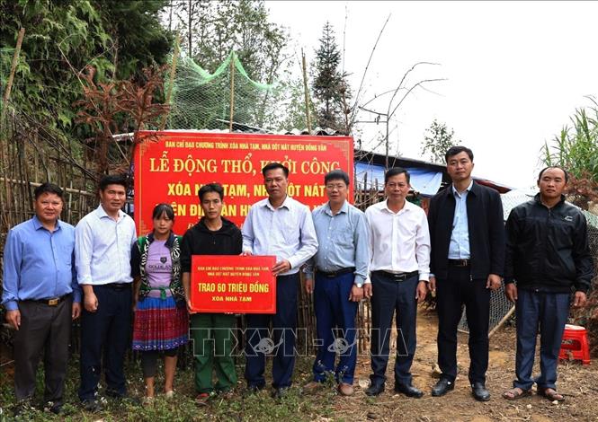 Lãnh đạo huyện Đồng Văn (Hà Giang) trao kinh phí hỗ trợ các hộ gia đình xóa nhà tạm, nhà dột nát. Ảnh: TTXVN phát