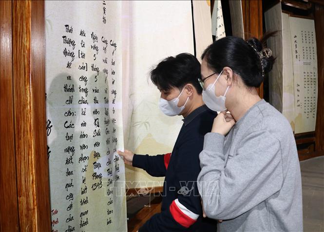 Du khách chiêm ngưỡng các tác phẩm thơ tại Hội quán. Ảnh: Thùy Dung - TTXVN