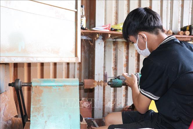 Hầu hết thợ ở làng nghề tủ thờ Gò Công đều đã áp dụng máy móc hiện đại vào sản xuất. Ảnh: Hữu Chí – TTXVN