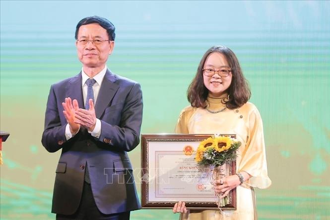 Bộ trưởng Bộ Thông tin và Truyền thông Nguyễn Mạnh Hùng trao tặng Bằng khen của Bộ trưởng cho nhà báo Đỗ Minh Thu, báo điện tử VietNamPlus (TTXVN). Ảnh: Minh Quyết - TTXVN