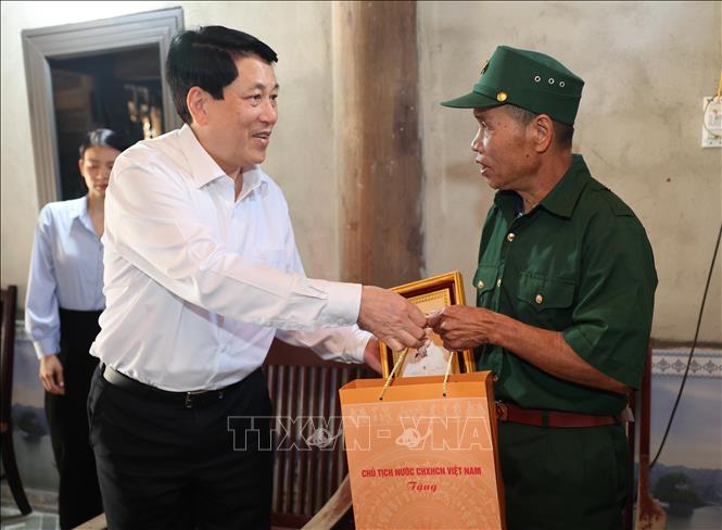 Chủ tịch nước Lương Cường tặng quà, động viên ông Lang Văn Sung, thương binh 1/4, thôn Khẹo, xã Bát Mọt, huyện Thường Xuân. Ảnh: Lâm Khánh - TTXVN