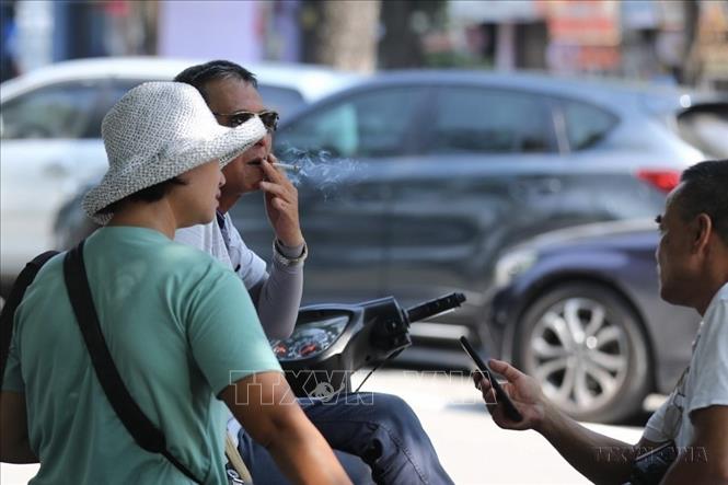 A smoker at a public place in Hanoi. VNA Photo