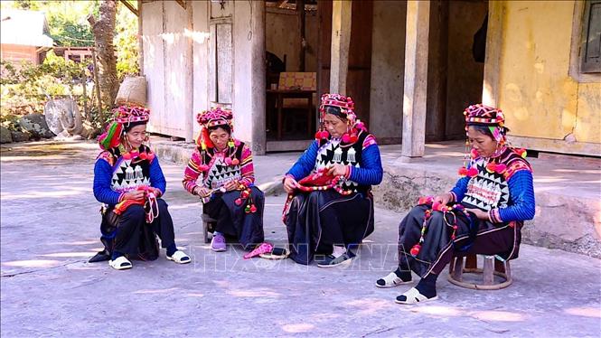 Women of the Ha Nhi community pour their hearts into crafting exquisite outfits. VNA/Photo by courtesy