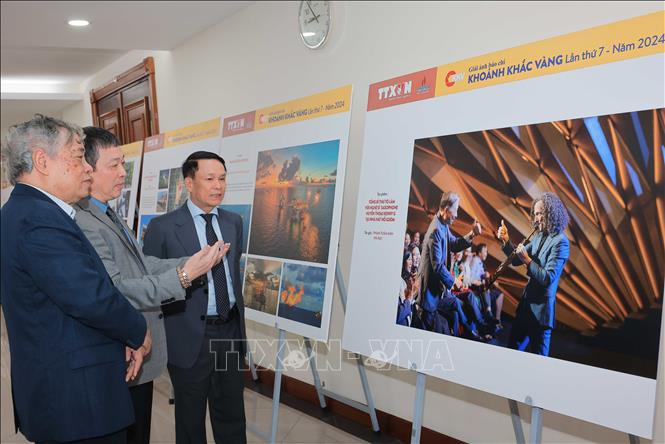 Đại biểu tham quan trưng bày các tác phẩm xuất sắc đoạt Giải ảnh báo chí Khoảnh khắc Vàng lần thứ 7. Ảnh: Hoàng Hiếu - TTXVN