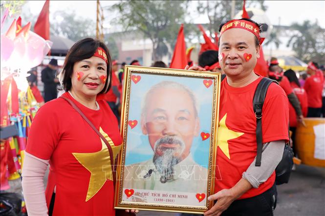 Cổ động viên mang theo ảnh Bác Hồ cổ vũ thầy trò Kim Sang Sik. Ảnh: Tạ Toàn - TTXVN