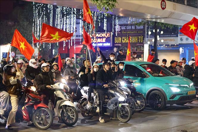 Người dân Thủ đô nghiêm chỉnh chấp hành luật giao thông, dừng đèn đỏ khi đi ăn mừng chiến thắng của tuyển Việt Nam. Ảnh: Thanh Tùng - TTXVN