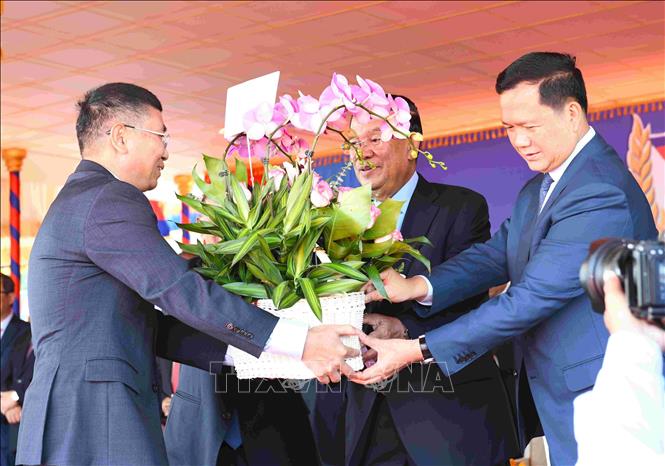 Đại biện lâm thời Đại sứ quán Việt Nam tại Vương quốc Campuchia Ngô Văn Tuất (trái) trao tặng giỏ hoa đến Ban lãnh đạo CPP, cùng thông điệp chúc mừng kỷ niệm. Ảnh: AKP/TTXVN phát 