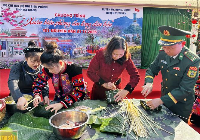 Dân bản và bộ đội biên phòng gói bánh chưng Tết. Ảnh: Đức Thọ - TTXVN