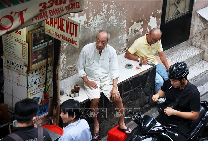 Sitting down and enjoying a cup of coffee in the morning has become a local tradition in Ho Chi Minh city. VNA Photo: Hồng Đạt