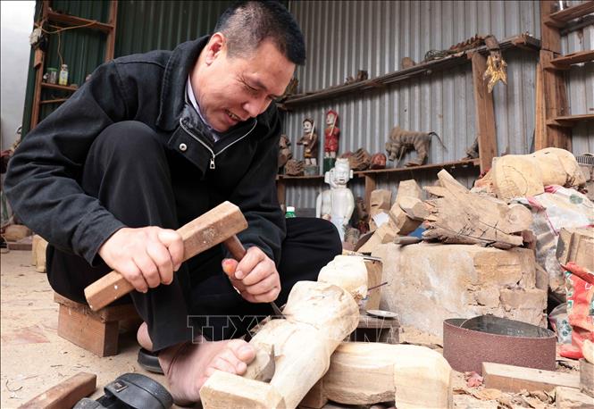 Nghệ nhân Nguyễn Văn Phi sớm được tiếp cận với nghề từ khi còn nhỏ, hiện là người duy nhất trong làng làm công việc chế tác rối nước. Ảnh: Trần Việt - TTXVN
