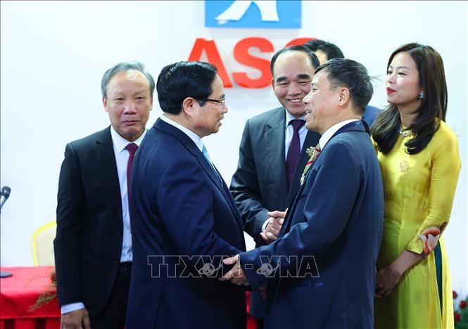 Prime Minister Pham Minh Chinh and representatives of overseas Vietnamese conducting business at the ASG Trade Centre. VNA Photo: Dương Giang