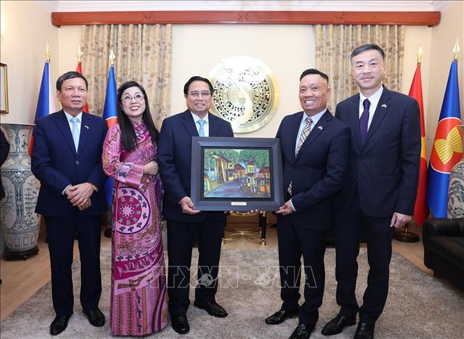 Prime Minister Pham Minh Chinh and his spouse present a gift to representatives of the Vietnamese community in the Czech Republic. VNA Photo: Dương Giang