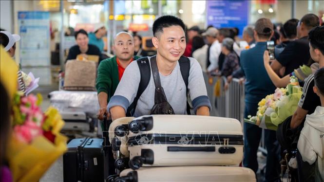 Hành khách từ nước ngoài trở về Việt Nam đón Tết tại nhà ga T2, sáng 27/1. Ảnh: TTXVN