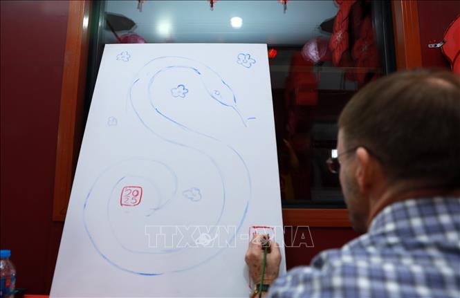 Các hoạ sĩ tham gia vẽ tranh trên toa cộng đồng. Ảnh: Quốc Khánh - TTXVN