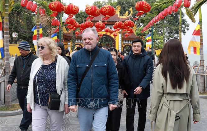 Ngưởi nước ngoài đang sống và làm việc tại Hà Nội cũng hoà mình vào dòng người Việt đi lễ đầu năm tại chùa Quán Sứ sáng mùng 1 Tết Ất Tỵ. Ảnh: Quốc Khánh - TTXVN