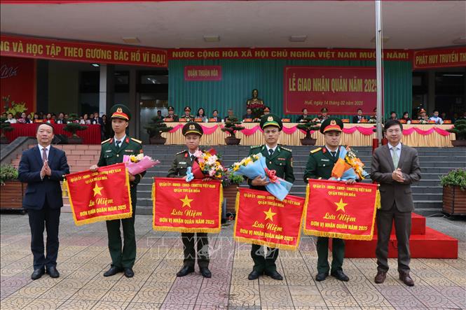 Lãnh đạo quận Thuận Hoá tặng hoa và cờ lưu niệm cho các đơn vị nhận quân. Ảnh: Mai Trang - TTXVN 