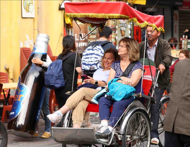 Foreign tourists take cycle tours of Hanoi's Old Quarter. VNA Photo: Phạm Kiên