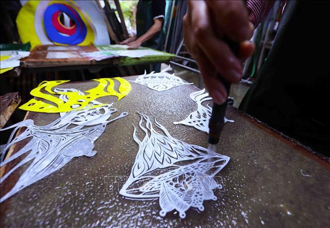 Để tạo tác “hoa văn chìm” trong từng tấm tranh Trúc Chỉ, người họa sĩ sử dụng phương pháp Trúc Chỉ graphy (vẽ bằng bút nước). Đây là công đoạn quan trọng nhất để tạo nên một tác phẩm tranh Trúc Chỉ. Ảnh: Vũ Sinh - TTXVN
 

