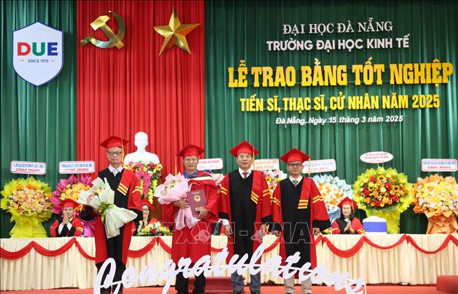 Lãnh đạo trường Đại học Kinh tế-Đại học Đà Nẵng trao bằng Tiến sĩ cho nghiên cứu sinh. Ảnh: Văn Dũng-TTXVN