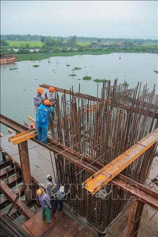 Công nhân đang tích cực thi công cầu Tam Tiến vượt sông Trường Giang trên tuyến đường Võ Chí Công. Ảnh: Hoàng Hiếu - TTXVN 