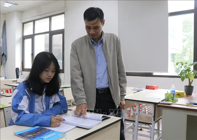 Thầy Lê Đăng Điển, giáo viên Toán trường THPT Chuyên Bắc Ninh và em Trương Thanh Xuân trong một buổi ôn luyện kiến thức. Ảnh: Thanh Thương - TTXVN