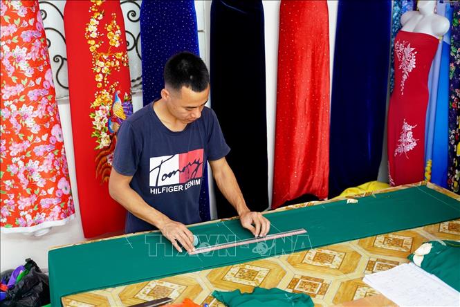Một điểm độc đáo ở làng nghề Trạch Xá là số đàn ông theo nghề may nhiều hơn phụ nữ do truyền thống từ xa xưa. Ảnh: Khánh Hoà - TTXVN                          