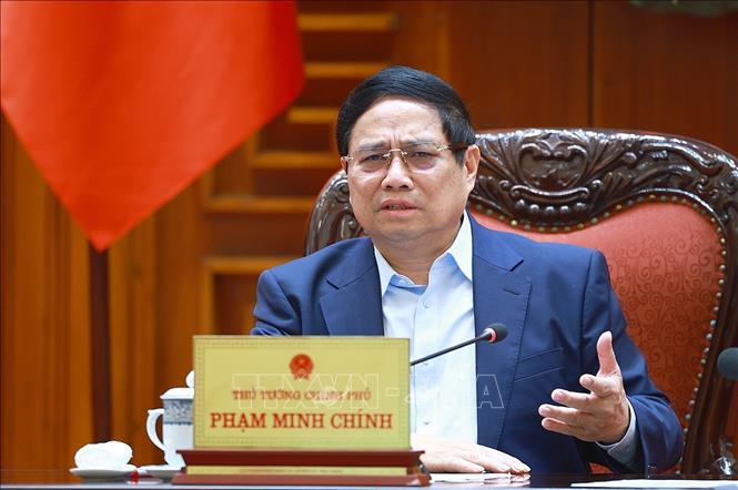 Thủ tướng Phạm Minh Chính chủ trì cuộc họp về mức áp thuế mới của Hoa Kỳ đối với hàng hoá nhập khẩu từ Việt Nam. Ảnh: Dương Giang-TTXVN 
