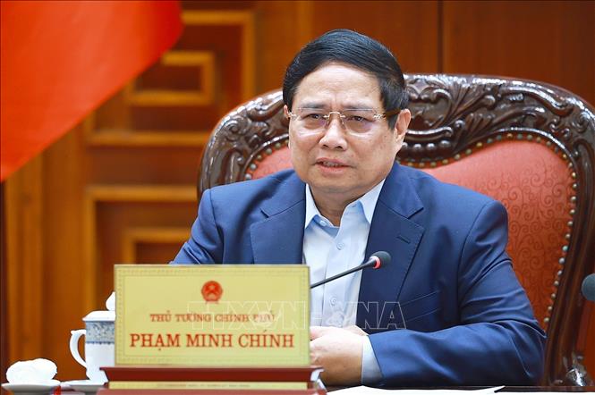 Thủ tướng Phạm Minh Chính chủ trì cuộc họp về mức áp thuế mới của Hoa Kỳ đối với hàng hoá nhập khẩu từ Việt Nam. Ảnh: Dương Giang-TTXVN 
