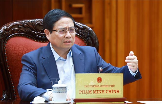 Thủ tướng Phạm Minh Chính chủ trì cuộc họp về mức áp thuế mới của Hoa Kỳ đối với hàng hoá nhập khẩu từ Việt Nam. Ảnh: Dương Giang-TTXVN 
