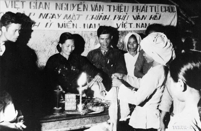 Phối hợp với du kích, bất chấp sự kìm kẹp của quân ngụy, đồng bào ấp chiến lược ở Lào Táo (Trung Hòa, Củ Chi) nổi dậy, phá ấp, đốt cờ ngụy. Ảnh: TTXVN