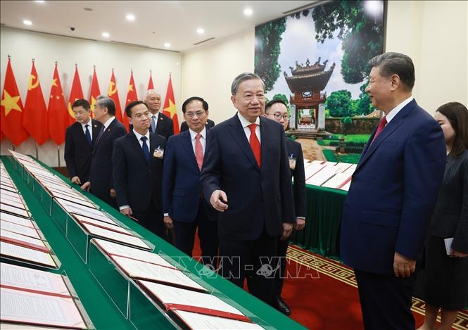 Party General Secretary To Lam and  General Secretary of the Communist Party of China Central Committee and President of China Xi Jinping witness the display of cooperation documents between the two countries in Hanoi on April 14. VNA Photo