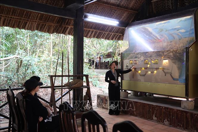 Hướng dẫn viên giới thiệu kết cấu của toàn bộ Địa đạo Củ Chi với du khách. Ảnh: Thu Hương - TTXVN