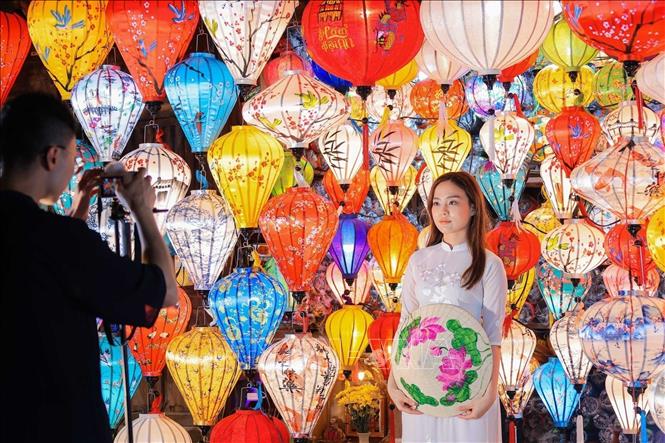 A girl poses with colourful lanterns in Hoi An, Quang Nam province. VNA Photo
