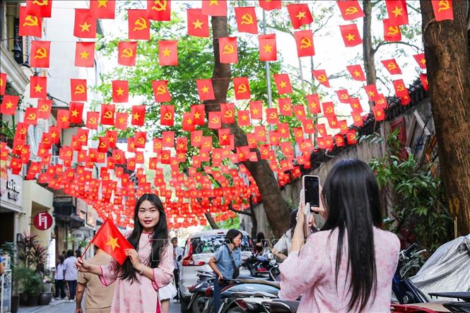 Lan tỏa tình yêu đất nước qua hình ảnh lá cờ Tổ quốc đang trở thành một xu hướng phổ biến trong giới trẻ. Ảnh: Khánh Hoà - TTXVN