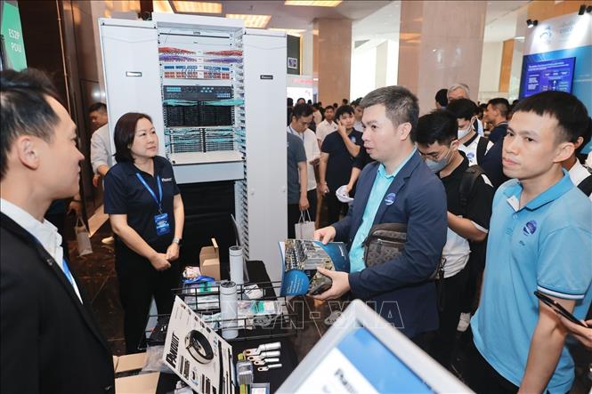 Đại biểu tham quan các gian trưng bày sản phẩm công nghệ trong lĩnh vực trung tâm dữ liệu, trí tuệ nhân tạo và điện toán đám mây toàn cầu. Ảnh: Minh Quyết - TTXVN