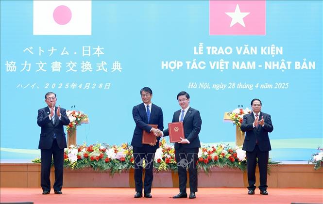Prime Minister Pham Minh Chinh and Japanese Prime Minister Ishiba Shigeru witness the handover ceremony of the framework agreement on teaching Japanese in Vietnamese high schools between the Ministry of Education and Training and the Embassy of Japan in Vietnam. VNA Photo: Dương Giang