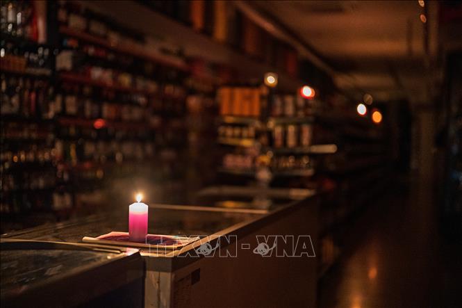 Thắp nến trong cửa hàng ở Barcelona, Tây Ban Nha khi điện bị mất trên diện rộng, ngày 29/4/2025. Ảnh: THX/TTXVN 