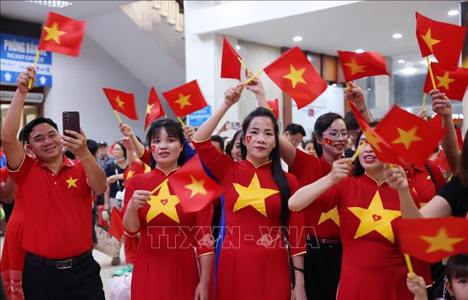 Nhân viên và người dân đi chuyến tàu SE1 xuất phát tại Ga Hà Nội cùng chung vui ca hát trước khi lên tàu. Ảnh: Quốc Khánh - TTXVN