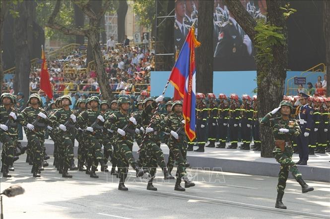 The Lao People's Army marches through the grandstand. VNA Photo