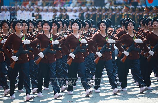 The female militia force marches through the grandstand. VNA Photo