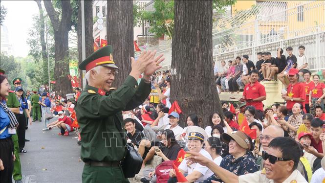 People stay up all night to wait for the parade. VNA Photo 