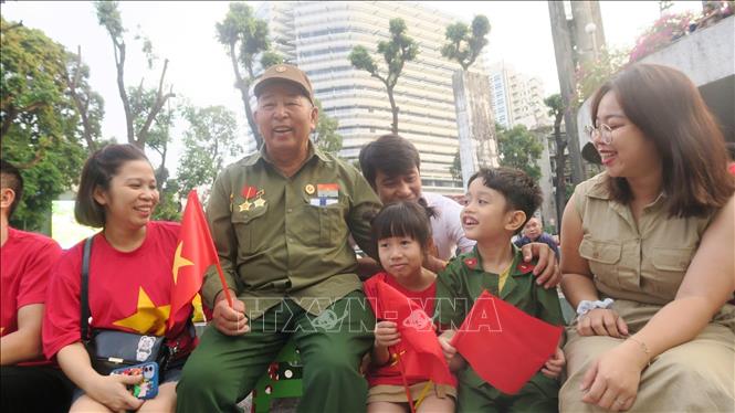 People from every corners of the country come to HCM City to watch the parade. VNA Photo 